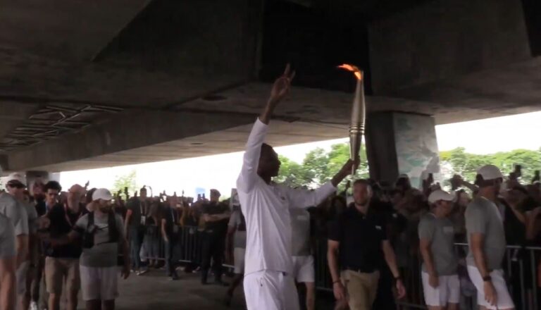 Snoop Dogg carrying the Olympic torch for the 2024 Paris Olympic