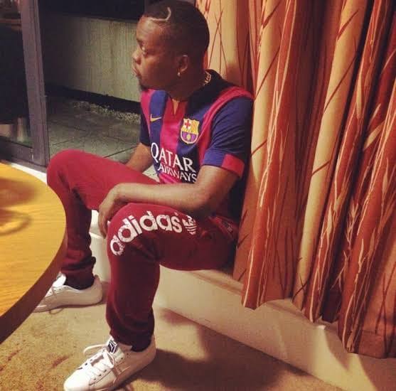 Olamide rocking his Barca jersey