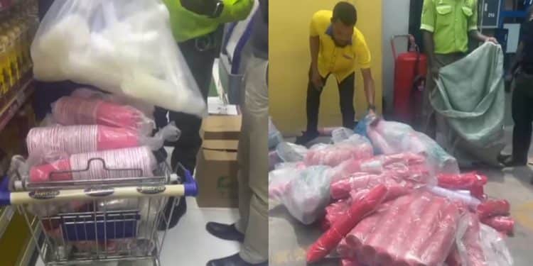 Lagos enforcement officers confiscating red plastic cups and pink plastic bags at Justrite Supermarket in Lekki.