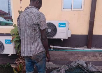 an standing with stolen wire mesh at Lagos KAI office after vandalism arrest