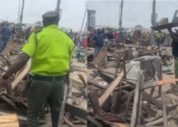 Lagos State Environmental Task Force officers are seen clearing a market area with street traders.