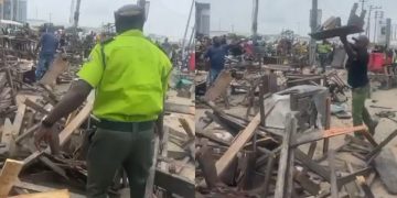 Lagos State Environmental Task Force officers are seen clearing a market area with street traders.