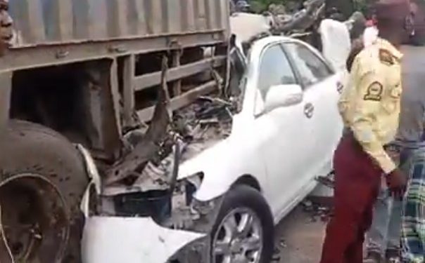 Car crash scene at Olohunsogo Bus Stop in Lagos with police managing traffic.