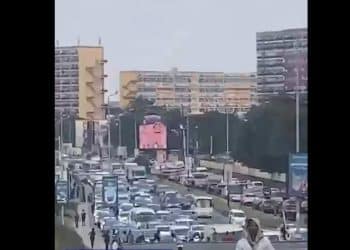 A long line of cars stuck in traffic on a busy Victoria Island road in the evening