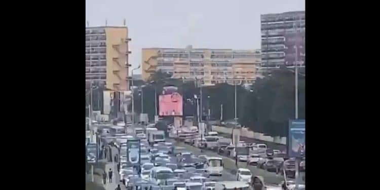 A long line of cars stuck in traffic on a busy Victoria Island road in the evening