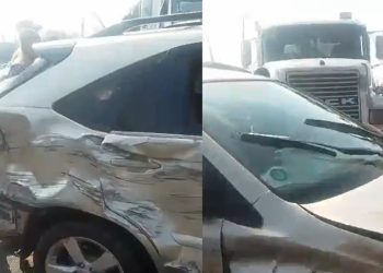 Scene of a road crash involving a truck and jeeps on a busy Lagos street with traffic officers present.