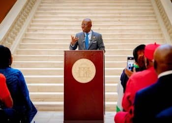 Governor Babajide Sanwo-Olu speaking at a podium in Atlanta.