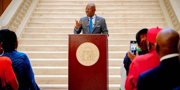 Governor Babajide Sanwo-Olu speaking at a podium in Atlanta.