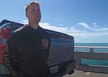Body camera footage showing a police officer conducting a field sobriety test on a highway shoulder at night in Florida.