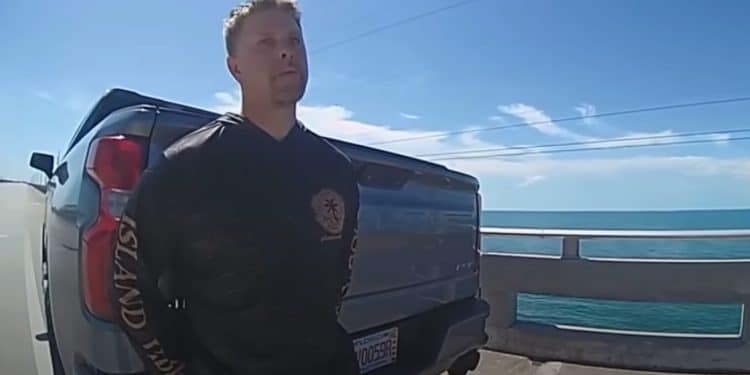 Body camera footage showing a police officer conducting a field sobriety test on a highway shoulder at night in Florida.