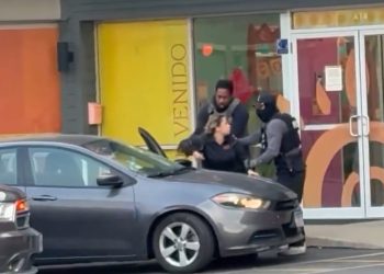Unmarked SUV and federal agents outside a day care center.