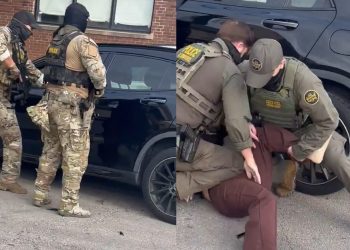 Photo of a chaotic street scene in Chicago with federal agents and a damaged car after a collision involving a US citizen.
