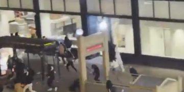 Photo of police responding to the mass shooting and riot near the Chicago Theater marquee after the Christmas tree lighting.